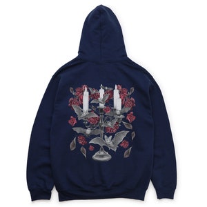 May include: A navy blue hooded sweatshirt with a graphic print of a candelabra with candles and bats surrounded by red roses.