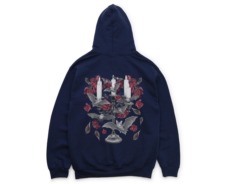 May include: A navy blue hooded sweatshirt with a graphic print of a candelabra with candles and bats surrounded by red roses.