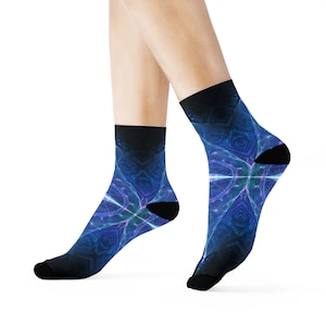 May include: Crew socks with a striking abstract pattern in blue, purple, and white. The socks have black heels, toes, and a black band at the top. The design is reminiscent of a fractal or geometric pattern. The socks are worn on a person's feet.
