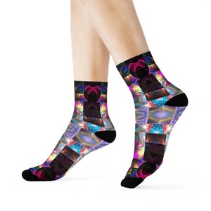 May include: A pair of colourful socks with a geometric pattern featuring bright pink, blue, green, and yellow hues. The socks are made of a soft, comfortable fabric and are perfect for adding a pop of colour to any outfit.