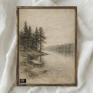 May include: Framed vintage landscape art print. The artwork depicts a serene lake scene with a cluster of evergreen trees on the shore. The print is in grayscale tones, with a sepia-toned background and a dark brown frame.