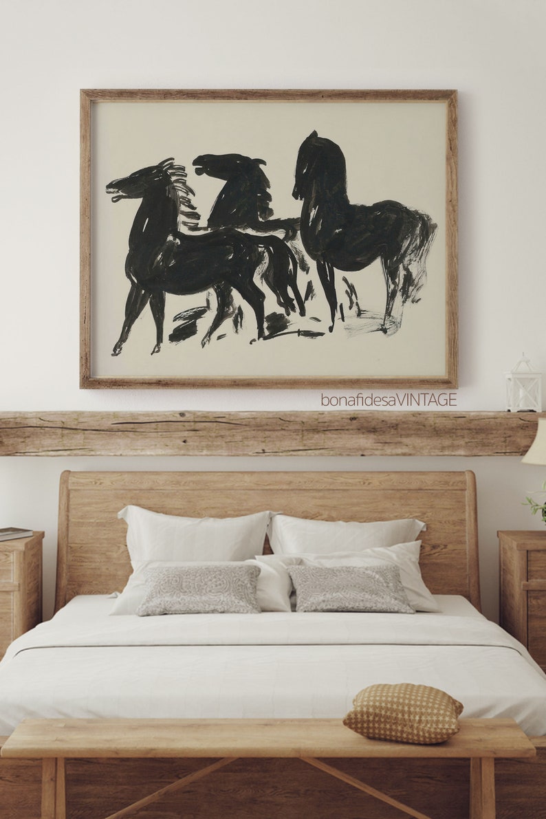 May include: A framed black and white line drawing of three horses in a minimalist style. The drawing is on a cream background and is framed in a natural wood frame. The frame has the text "bonafidesaVINTAGE" printed on the bottom.