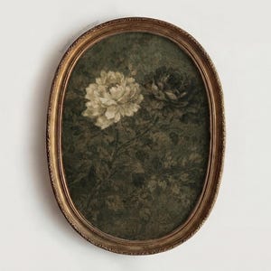 May include: An oval framed print featuring two peony flowers in shades of cream and dark green. The flowers are set against a dark green background with subtle floral patterns. The frame is a warm, antique gold color, adding to the vintage aesthetic.