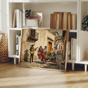 May include: A framed wall art print depicting a street scene with a musician playing a guitar and three dancers in colorful, wide-skirted dresses. The setting features stone buildings, a balcony, and hanging festive banners in a warm, sunlit tone.