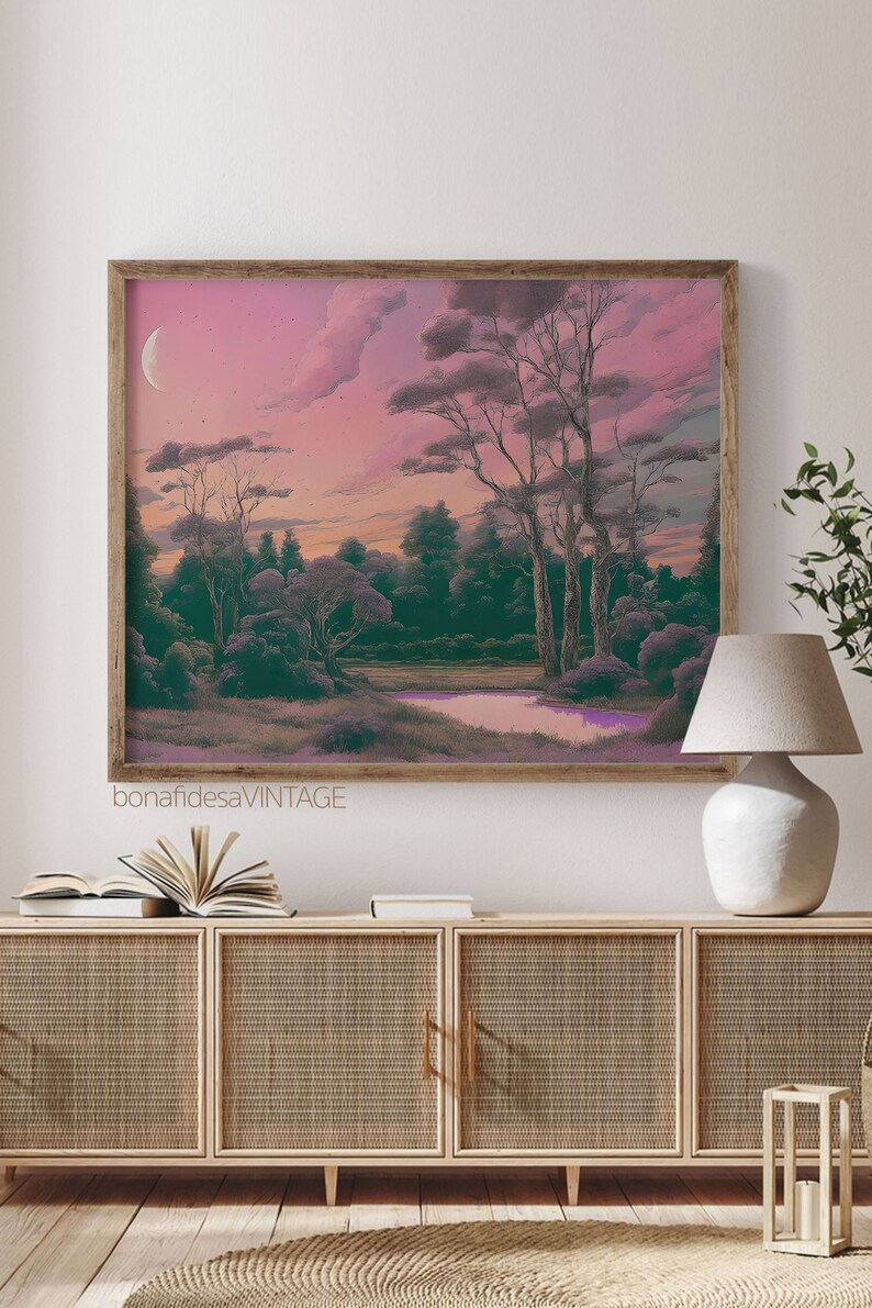 May include: A framed print of a landscape painting with a pink and purple sky, green trees, and a small body of water. The text "bonafidesavintage" is at the bottom of the print.