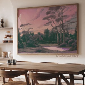 May include: A framed print of a landscape painting with a pink sky, a crescent moon, and a river winding through a forest. The trees are silhouetted against the sky, and the river is reflecting the pink light of the sky.