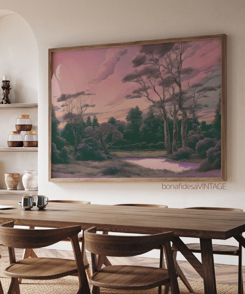 May include: A framed print of a landscape painting with a pink sky, a crescent moon, and a river winding through a forest. The trees are silhouetted against the sky, and the river is reflecting the pink light of the sky.