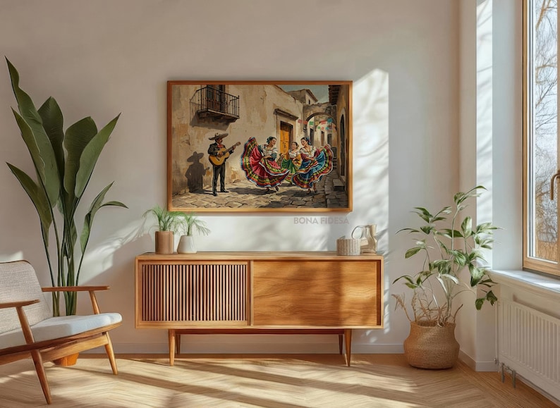 May include: A rectangular framed wall art print depicting a scene of a musician playing a guitar while three individuals in colorful, multi-layered dresses dance on a cobblestone street in front of beige buildings with a balcony and archway.