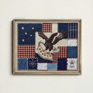 May include: Framed patriotic patchwork art featuring an embroidered bald eagle holding a banner with stars. The artwork incorporates blue, red, and white fabric squares with star and bell motifs, creating a vintage Americana theme.