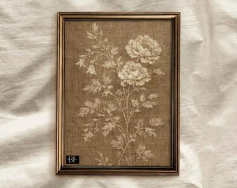Puede incluir: Una impresión botánica enmarcada con un diseño floral en tonos beige y crema. La obra de arte está enmarcada en un marco rectangular marrón oscuro. La impresión muestra una ilustración detallada de flores y follaje, creando una estética vintage.