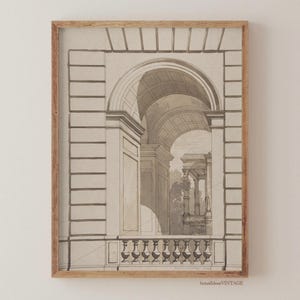 May include: Framed architectural print in sepia tones. The artwork depicts a classical building facade with arched openings, columns, and a balustrade. The drawing style is detailed, with shading to create depth and dimension. The frame is a light brown color.