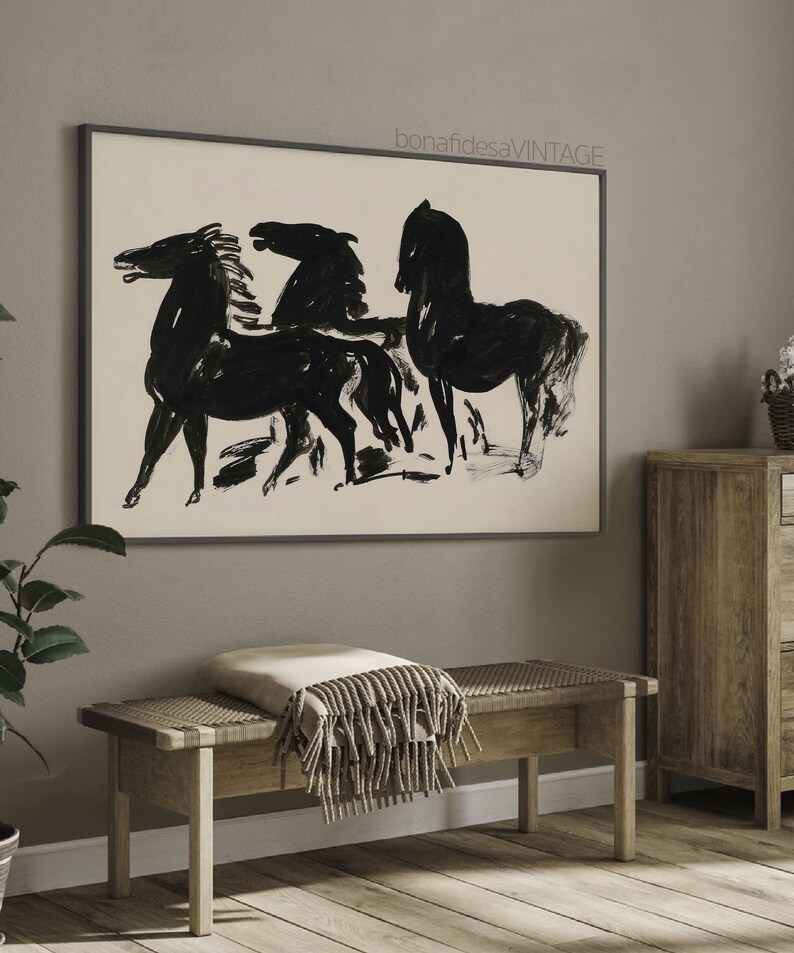 May include: Black and white abstract painting of three horses in a minimalist style. The painting is framed in a black frame and hangs on a gray wall.