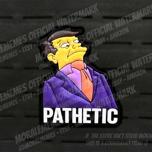 May include: A cartoon character with yellow skin and black hair is wearing a purple suit and a purple tie with a white shirt. The character is looking to the right and has a serious expression. The text "PATHETIC" is written in white letters on a black background.
