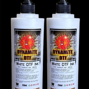 May include: Two white bottles of Dynamite DTF white ink, each containing 250 ml of ink. The bottles have black caps and labels with red and white graphics. The labels say "Dynamite DTF" and "White DTF Ink".