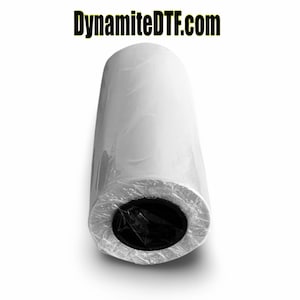 May include: A white roll of heat transfer vinyl wrapped in clear plastic. The roll is approximately 12 inches in diameter and is labeled with the website "DynamiteDTF.com".