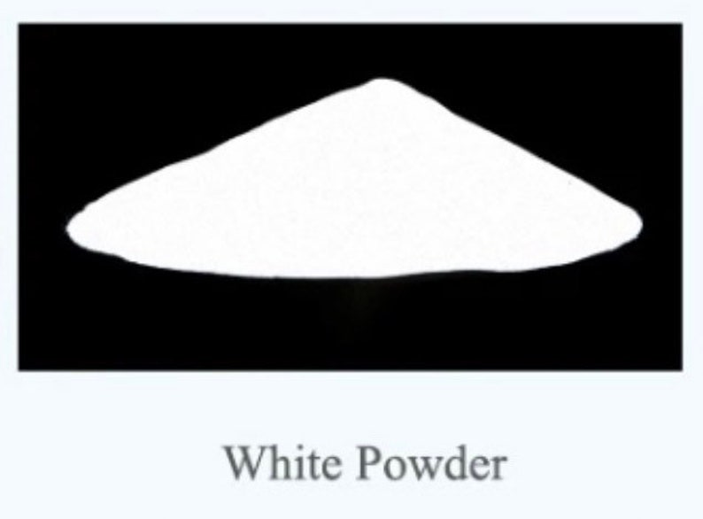 May include: A mound of fine white powder centered against a solid black background. The substance is piled into a conical shape with a smooth, uniform texture. Below the image, the text White Powder is printed in a simple, dark gray font.