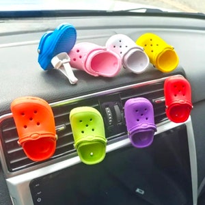 May include: Assortment of colorful car air freshener clips shaped like clogs. The clips are in various colors, including blue, pink, yellow, green, purple, and red.