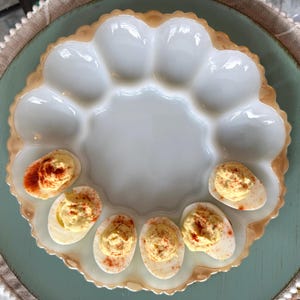 May include: A set of three ceramic mugs with a speckled, matte finish. Each mug features a different color: light blue, cream, and gray. The mugs have a simple, modern design and a comfortable handle.