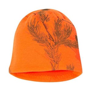 May include: Orange beanie with a camouflage pattern of brown pine branches.