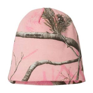 May include: Pink beanie with a camouflage pattern featuring branches and leaves. The beanie has the text "REALTREE" printed on the front.