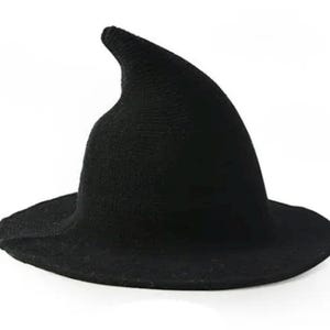 May include: A black witch's hat with a broad brim and a pointed, curved tip. The hat is made of a textured fabric, possibly knitted or woven, and is set against a white background. A classic Halloween costume accessory.