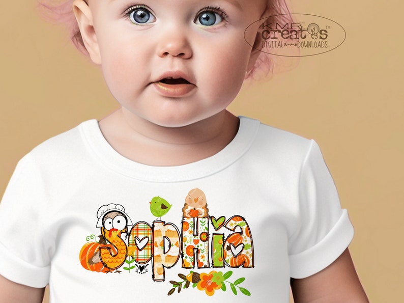 May include: A white baby onesie with a Thanksgiving-themed design featuring a turkey, pumpkins, and the name "Sophia".