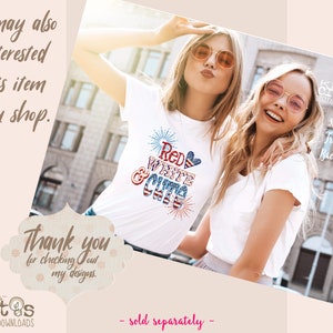May include: Two women wearing white t-shirts, one with a red, white, and blue graphic that says "Red White & Cute" with fireworks and a heart. The women are smiling and wearing sunglasses. The background is a city street.