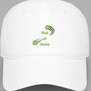 May include: White baseball cap with green embroidery that says "Dink or Doink" with two green circles and a green line.