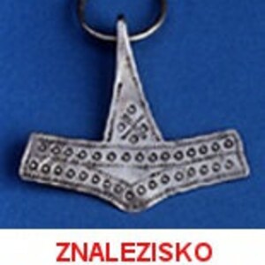 May include: A silver-colored pendant in the shape of a hammer, attached to a metal ring. The hammer has a detailed design with small circular and cross-shaped patterns. The text "ZNALEZISKO ARCHEOLOGICZNE" is displayed in red at the bottom.