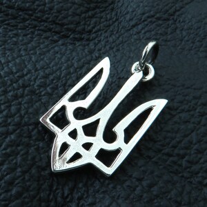 May include: Silver pendant in the shape of the Ukrainian trident, a traditional symbol of Ukraine.