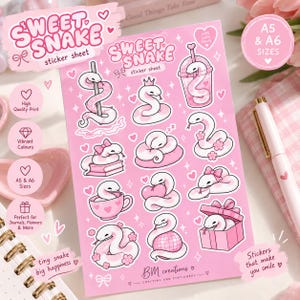 May include: A pink sticker sheet titled Sweet Snake featuring various illustrations of white snakes with pink accents, including snakes with bows, in a cup, on a book, with a heart, and in a gift box, with text reading BM creations crafting and stationery.