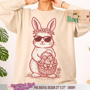Puede incluir: Una sudadera beige con un gráfico rojo de un conejito con gafas de sol y una corona de flores, sosteniendo una cesta de huevos de Pascua. El diseño incluye el texto "The Handsome Peanut" y "100% MY ORIGINAL IDEA". El diseño es de 68,58 cm x 68,58 cm a 300 DPI.
