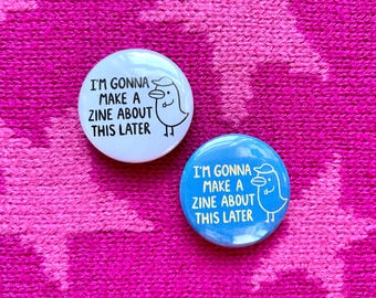 May include: Two round buttons with a white background and blue background. Both buttons feature a cartoon bird with a hat and the text "I'm gonna make a zine about this later."