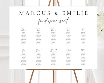 May include: A white seating chart with black text for a wedding reception. The chart is titled "Marcus & Emilie find your seat". The names of guests are listed under table numbers one through ten.