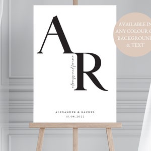 May include: A black and white printable wedding sign with the letters "A" and "R" stacked on top of each other. The text "always and forever" is written in cursive script next to the letters. The text "ALEXANDER & RACHEL" and "15.06.2022" is below the letters. The text "AVAILABLE IN ANY COLOUR OF BACKGROUND & TEXT" is in the top right corner.