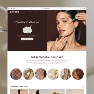 May include: A website interface for Layers featuring a dark brown header with the text Tapestry of Vibrance and a photograph of a person applying a clear liquid serum from a glass dropper bottle to their cheek. Below are circular images.