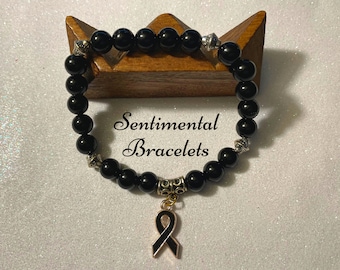 Black Awareness Bracelet with Ribbon Charm made out of 100% Black Onyx Gemstone Beads