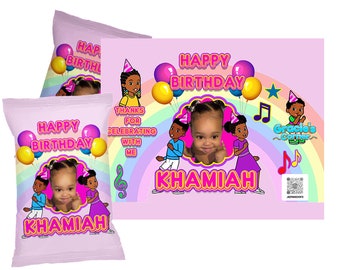 May include: Two pink and purple chip bags with a rainbow, musical notes, and a photo of a young girl. The bags say "Happy Birthday Khamiah".