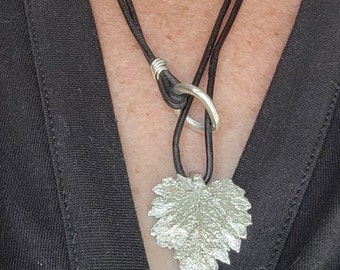 Pure silver maple leaf pendant on a black leather lariat rope.