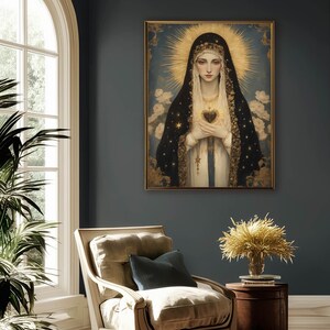 May include: A framed religious portrait depicts a woman with a halo, wearing a black veil adorned with gold stars. She holds a heart, set against a blue background with white flowers. The artwork hangs in a room with a chair and a side table.