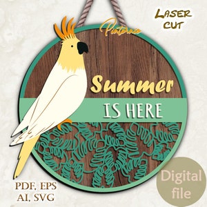 May include: A round wooden sign with a green and blue tropical leaf design. The sign features a white cockatoo with yellow accents and the text "Summer is Here".