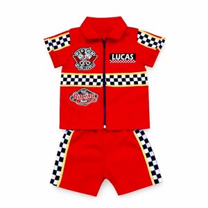 May include: A red short-sleeve collared shirt with a front zipper and matching shorts. The set features black and white checkered trim, a Piston Racing emblem, a Sport Car Racing Team patch, and the name LUCAS printed on the chest area.