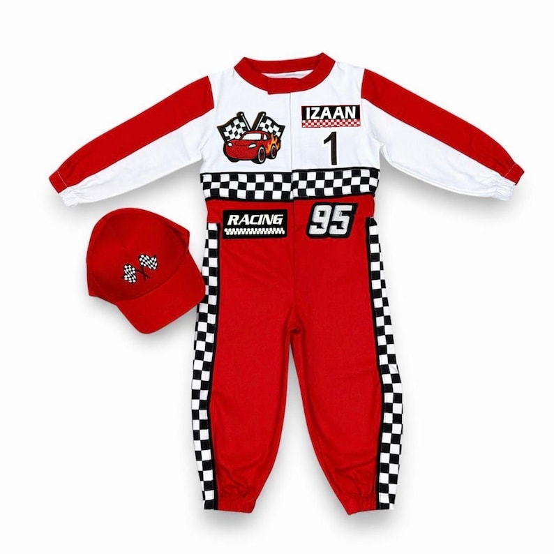 May include: A red and white racing-themed jumpsuit with long sleeves, a checkered pattern across the waist and sides, and a matching red baseball cap. The jumpsuit features the name IZAAN, the number 1, the number 95, and a red car graphic.