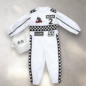 May include: White racing jumpsuit with black accents, a checkered flag patch, and the name "NOAH" and the number "2". Includes a matching white cap with checkered flags. The jumpsuit has the number "55" and the word "RACING".