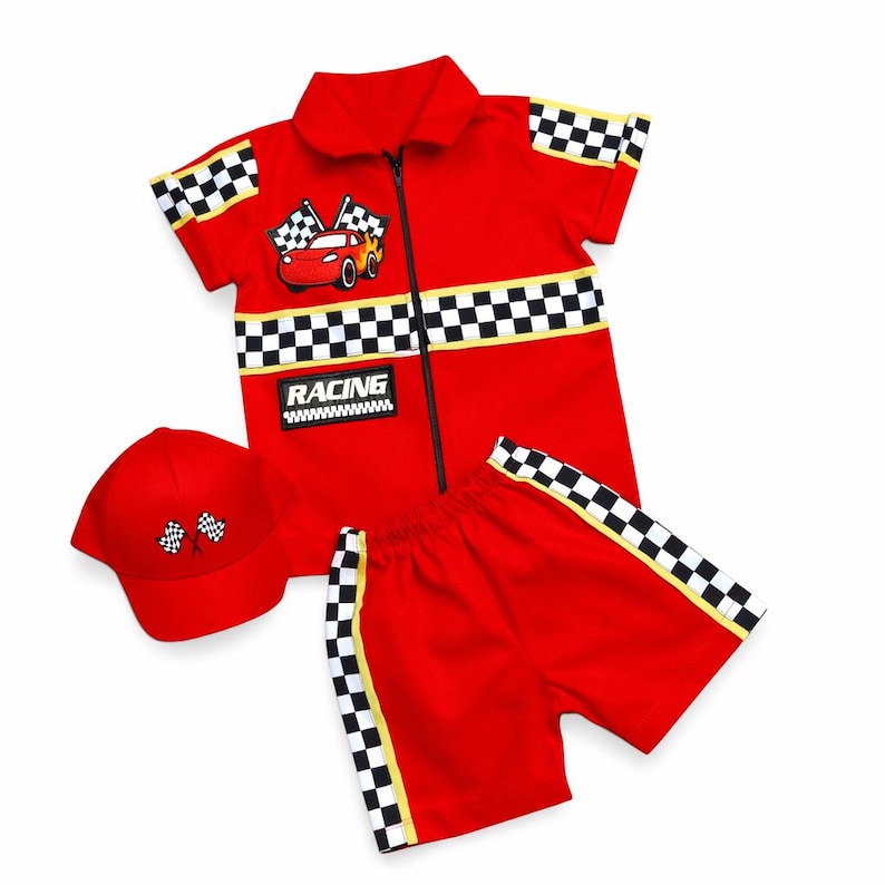 May include: A red short-sleeved zip-up shirt, matching shorts, and a baseball cap. The shirt features a black and white checkered pattern on the sleeves and midsection, a red car graphic, and a patch with the text RACING. The cap has two crossed checkered flags.