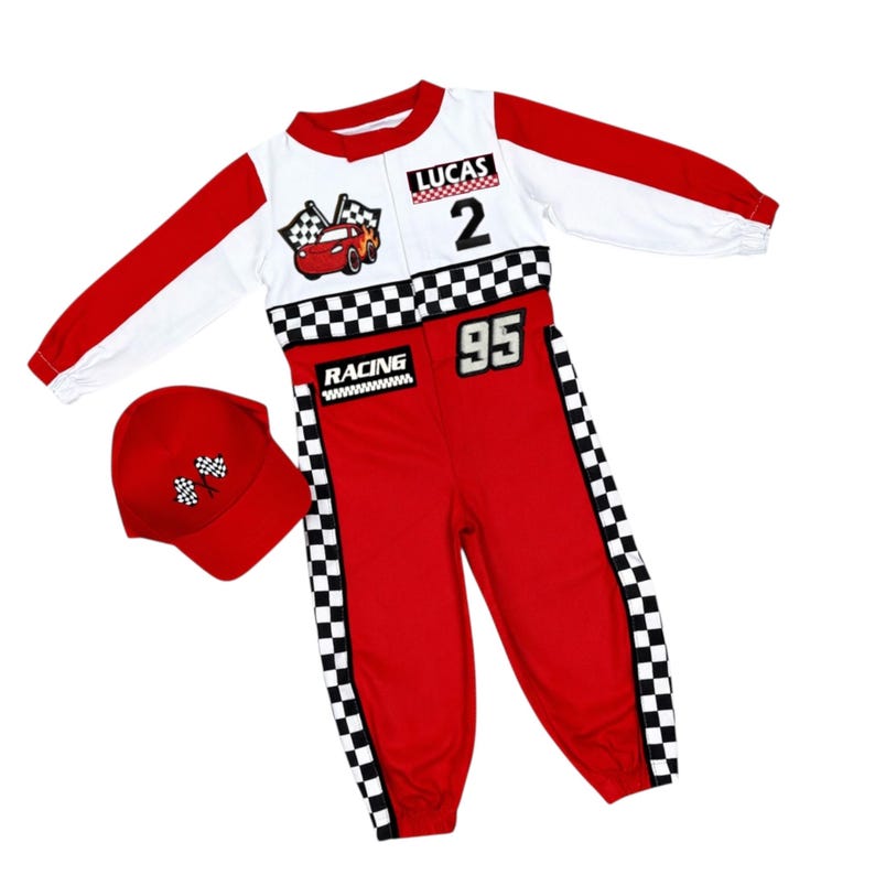 May include: A red and white racing-themed jumpsuit featuring long sleeves, a checkered pattern, the name LUCAS, the number 2, the number 95, the word RACING, and a cartoon car graphic. A matching red baseball cap with a checkered flag emblem is included.