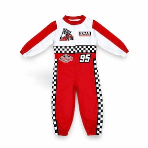 May include: A long-sleeve racing-style jumpsuit in red and white with black and white checkered patterns on the chest and legs. The garment features a graphic of a red race car with a checkered flag, the name IZAAN, and the number 95 printed on it.