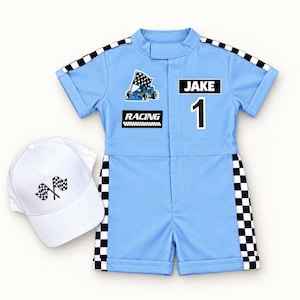 May include: A light blue short-sleeve romper with black and white checkered trim on the sleeves and sides. The romper features a race car graphic, the text "RACING", the name "JAKE", and the number "1". A white baseball cap with two checkered flags.