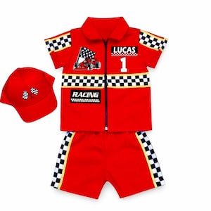 May include: A red short-sleeve collared shirt with a zipper, matching shorts, and a baseball cap. The set features black and white checkered patterns, a race car graphic, the name LUCAS, the number 1, and the text RACING on the shirt.