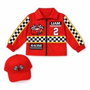 May include: A red zip-up jacket with a collar, featuring black and white checkered stripes on the sleeves and torso, a race car graphic, the name LIAM, the number 2, and the word RACING. A matching red baseball cap with two checkered flags.